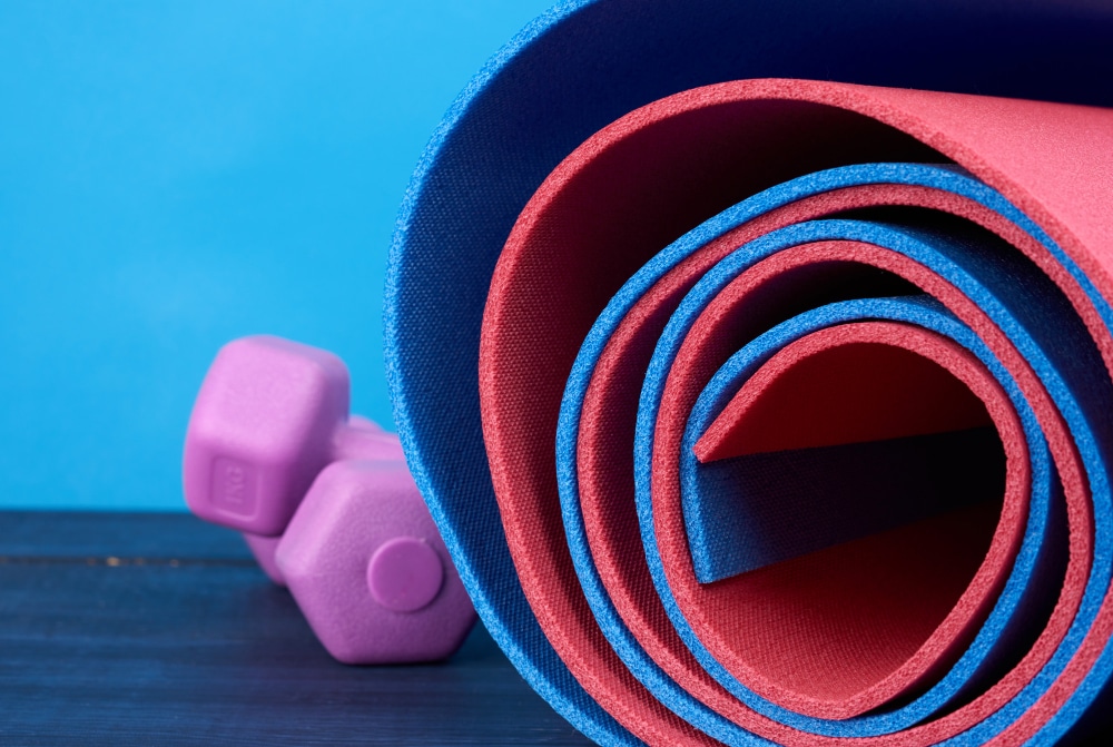 Image of dumbbells and yoga mats made of neoprene material